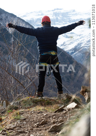 Man in body harnesses feature life-safety, viaferrata in mountains of pyrenees Man in body harnesses feature life-safety, viaferrata in mountains of pyrenees 113071018
