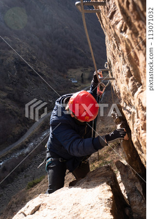 Man in body harnesses feature life-safety, viaferrata in mountains of pyrenees 113071032