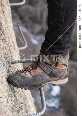 Man in body harnesses feature life-safety, viaferrata in mountains of pyrenees 113071070