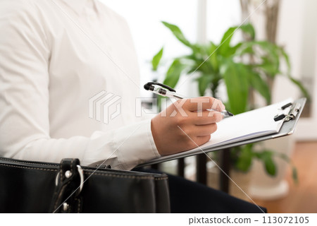 Business person writing on paper 113072105