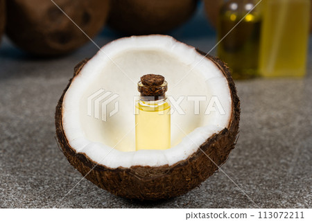 Coconut oil in a small glass bottle for skin and hair care. 113072211