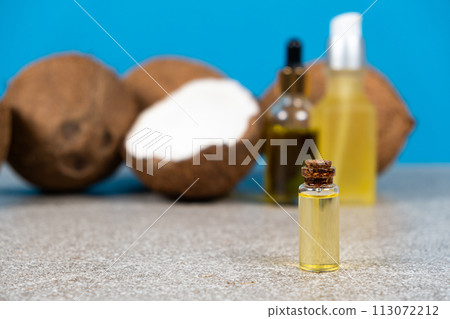 Coconut oil in a small glass bottle for skin and hair care. Coconut oil in a small glass bottle for skin and hair care. 113072212