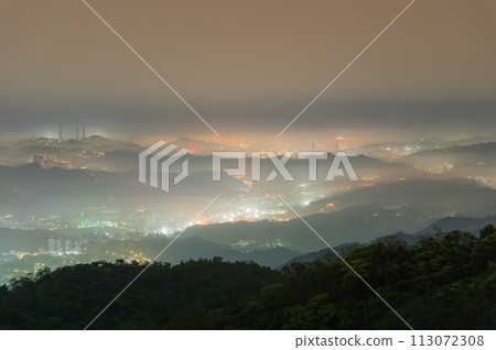 A mesmerizing white mist hangs over the city in the valley. Colorful skyline. 113072308