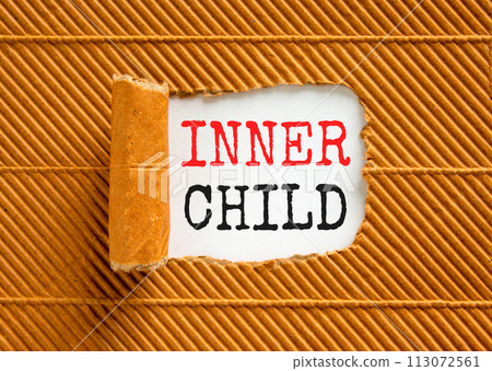 Inner child symbol. Concept words Inner child on beautiful white paper. Beautiful brown paper background. Psychological, motivational inner child concept. Copy space. 113072561