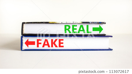 Real or fake symbol. Concept word Real or Fake on beautiful books. Beautiful white table white background. Business and real or fake concept. Copy space. Real or fake symbol. Concept word Real or Fake on beautiful books. Beautiful white table white background. Business and real or fake concept. Copy space. 113072617