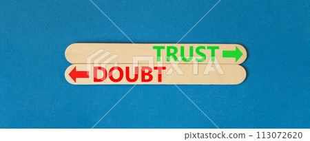 Trust or doubt symbol. Concept word Trust or Doubt on beautiful wooden stick. Beautiful blue table blue background. Business and trust or doubt concept. Copy space. 113072620