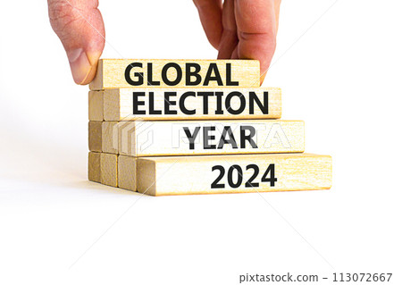 Global election year 2024 symbol. Concept words Global election year 2024 on beautiful block. Beautiful white table white background. Voter hand. Business Global election year 2024 concept. Copy space 113072667
