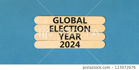 Global election year 2024 symbol. Concept words Global election year 2024 on wooden stick. Beautiful blue table blue background. Business Global election year 2024 concept. Copy space. Global election year 2024 symbol. Concept words Global election year 2024 on wooden stick. Beautiful blue table blue background. Business Global election year 2024 concept. Copy space. 113072676