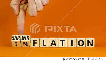 Inflation or shrinkflation symbol. Concept words Inflation Shrinkflation on beautiful wooden blocks. Beautiful orange background. Businessman hand. Business inflation shrinkflation concept. Copy space 113072719