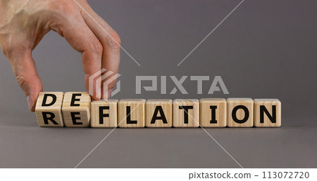 Deflation or reflation symbol. Businessman turns cubes and changes the word deflation to reflation. Beautiful grey background, copy space. Business, deflation or reflation concept. Deflation or reflation symbol. Businessman turns cubes and changes the word deflation to reflation. Beautiful grey background, copy space. Business, deflation or reflation concept. 113072720