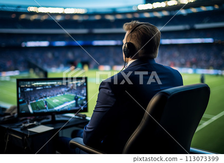 a sports commentator sits at the monitor against the backdrop of the football field of the stadium a sports commentator sits at the monitor against the backdrop of the football field of the stadium 113073399