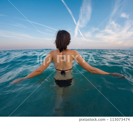 Woman on tropical vacation paradise on sea. Summer sea joy in Turkish seacoast, beaches along Lycian Way, Turkish Riviera. Asian female underwater and turquoise ocean around. 113073474