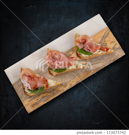 Prosciutto bruschetta with fresh ingredients Prosciutto bruschetta with fresh ingredients 113073742