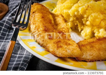 Fried pieces of breaded zander. 113073791