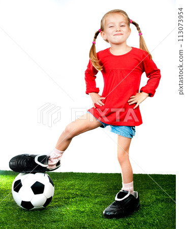 girl with soccer ball in boots on a green lawn 113073954