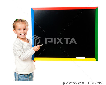 cute little girl standing near blackboard isolated on white cute little girl standing near blackboard isolated on white 113073958