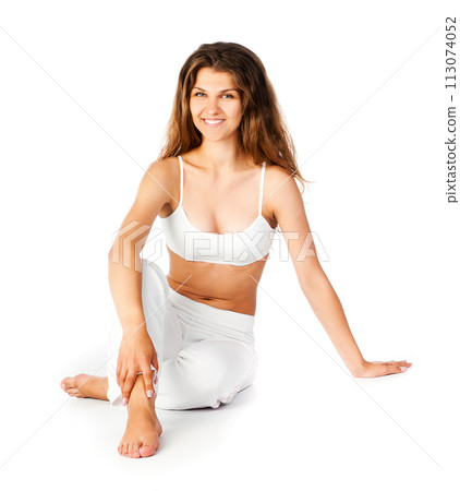 young woman doing fitness exercises on a white background 113074052