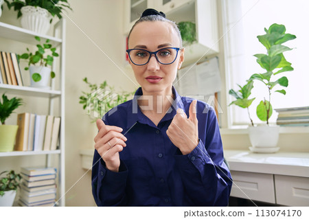 Serious confident business woman talking to web camera 113074170