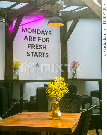 Motivational Interior of a restaurant at Przemysl, Poland. Vase wit yellow flowers. 113074399