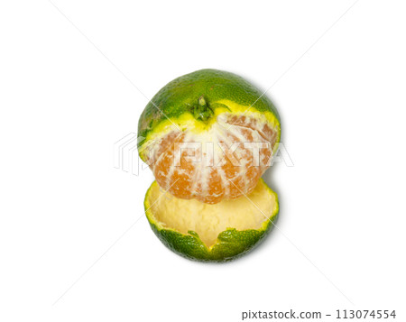 Unripe tangerine. Peeling a tangerine. Green fruit on a white background. Sour ingredient. Citrus isolate. 113074554