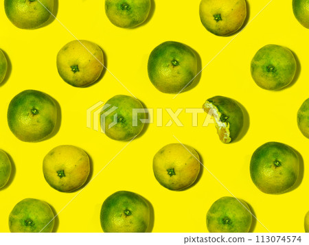 Unripe tangerine on a yellow background. Peeling a tangerine. Green and yellow color. Sour ingredient. Citrus isolate. Sliced tangerine. Useful fruit. citrus concept. Unripe tangerine on a yellow background. Peeling a tangerine. Green and yellow color. Sour ingredient. Citrus isolate. Sliced tangerine. Useful fruit. citrus concept. 113074574