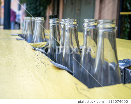 Decorative empty bottles. Table at the bar on the street. Bar decoration. Decorative empty bottles. Table at the bar on the street. Bar decoration. 113074600