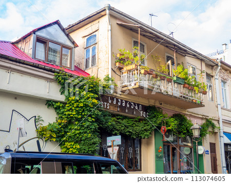 Streets of the southern city. Ivy on the building. Resort place. Streets of Batumi. House overgrown with greenery. Beautiful facade. Nature and architecture. 113074605