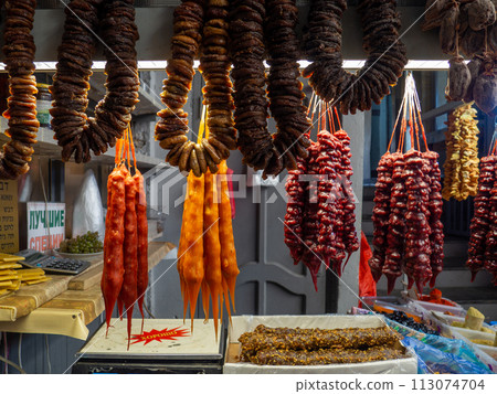 Peeled Georgian nuts. Background of nuts without shells. Snack on the table. Squirrel food. Lots of nuts. Hearty ingredient. Tasty food. Market stall. Bundles of figs 113074704