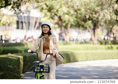 Asian businesswoman go to work at office stand and smiling wear backpack with bicycle. Bike commuting, Commute on bike, Business commuter concept. Asian businesswoman go to work at office stand and smiling wear backpack with bicycle. Bike commuting, Commute on bike, Business commuter concept. 113074769