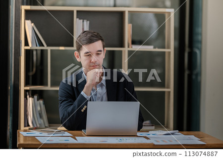 Handsome well dressed businessman working at his office, businessman working on a project Handsome well dressed businessman working at his office, businessman working on a project 113074887