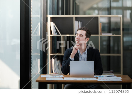 Handsome well dressed businessman working at his office, businessman working on a project Handsome well dressed businessman working at his office, businessman working on a project 113074895