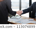 Business people in office suits standing and shaking hands, close-up. Business communication concept. Handshake and marketing 113074899