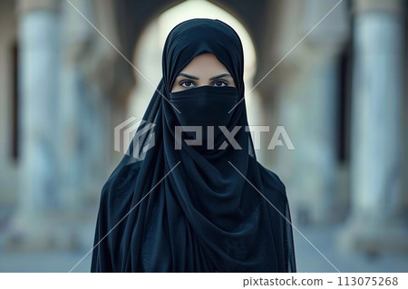 Muslim woman wearing niqab looking at the camera in the mosque 113075268