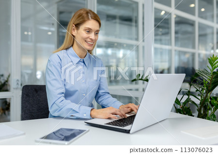 Focused professional utilizing laptop for business tasks in a bright, contemporary office setting. Concept of work and achievement. Focused professional utilizing laptop for business tasks in a bright, contemporary office setting. Concept of work and achievement. 113076023