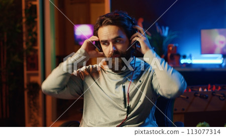 Upset gamer scolding teammates after losing competitive esports match, feeling disappointed. Angry player arguing with internet friends after being defeated in online videogame, facepalming himself 113077314