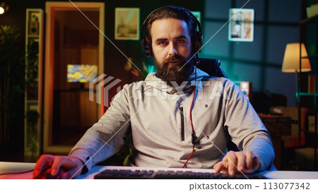 POV shot of pro gamer developing strategies for video games and presenting them to gaming community during livestream. Man testing different approaches to win videogame while streaming for fans 113077342