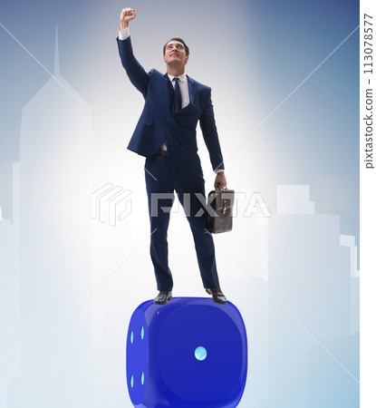 Businessman balancing on top of dice stack in uncertainty concep 113078577