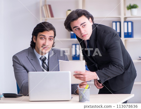Two young employees working in the office 113078636