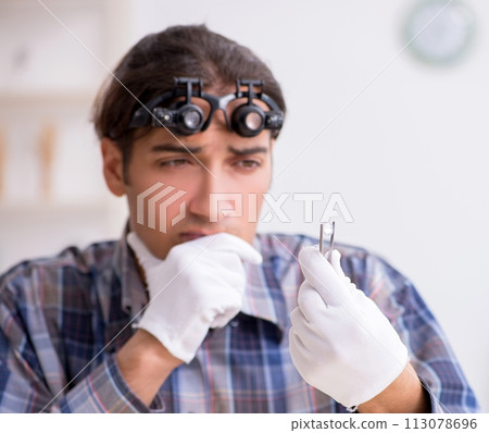 Young male jeweler at workshop 113078696