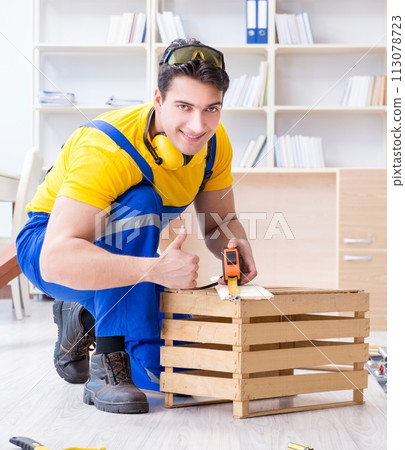 Repairman carpenter working with wooden board plank and measurin 113078723