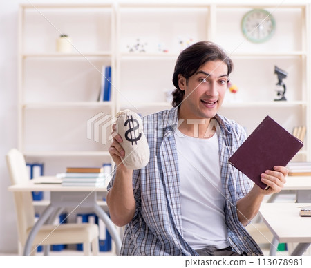 Young male student preparing for exams at home 113078981