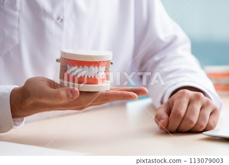 Male doctor stomatologist working in the clinic Male doctor stomatologist working in the clinic 113079003