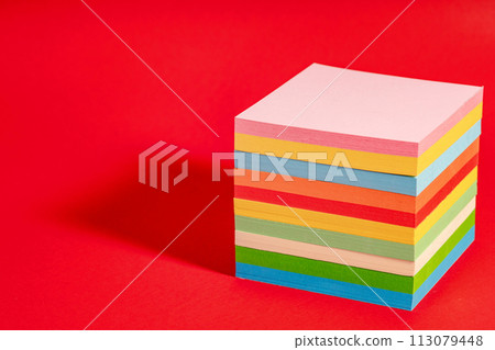 Stack of colorful sticky notes isolated on red background 113079448
