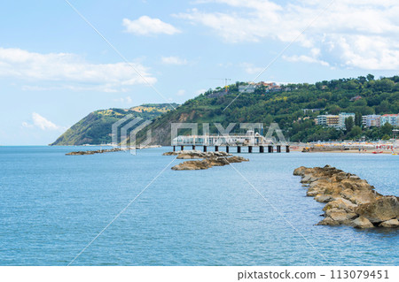 Coastal landscape on bright day with partly cloudy skies. Rocky formations Coastal landscape on bright day with partly cloudy skies. Rocky formations 113079451