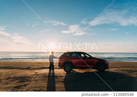 sandy beach, red car and man sandy beach, red car and man 113080586