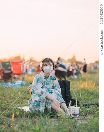 A woman in a yukata relaxing outdoors A woman in a yukata relaxing outdoors 113082009