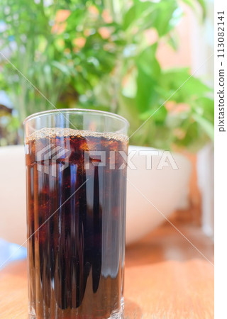 Iced coffee taken in front of plants Iced coffee taken in front of plants 113082141