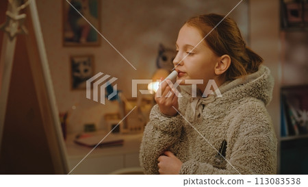 Young girl does makeup standing and taking picture in the mirror Young girl does makeup standing and taking picture in the mirror 113083538