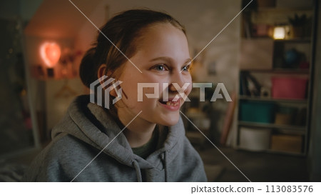 Young girl in headphones uses smartphone, then talks with friend Young girl in headphones uses smartphone, then talks with friend 113083576