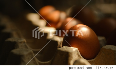 Chicken eggs placed in a cardboard box placed in the kitchen Chicken eggs placed in a cardboard box placed in the kitchen 113083956